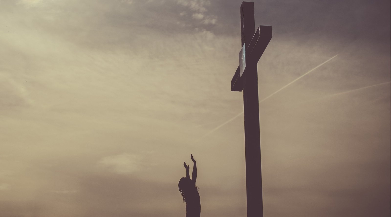 reaching up to a cross